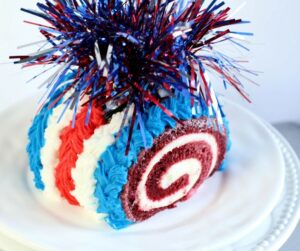 Firecracker Cake Roll - red velvet cake roll with red, white, and blue icing and cake topper