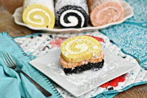Brie Brie Blooms photo with Lemon, Chocolate, and Strawberry cake roll on multiple colored napkins and white plates