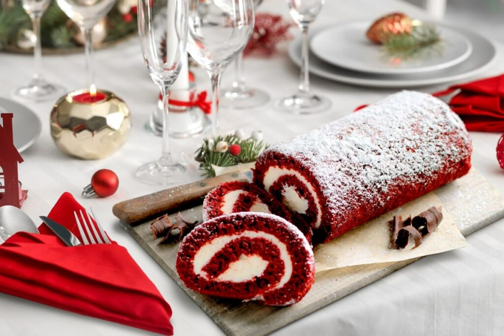 Essentials for Holiday Entertaining - Red Velvet Cake Roll on Christmas themed dining table