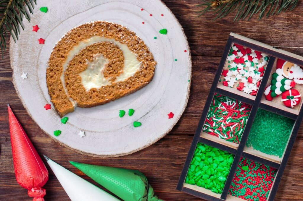 Essentials for Holiday Entertaining - Slice of Pumpkin Cake Roll with frosting and sprinkles
