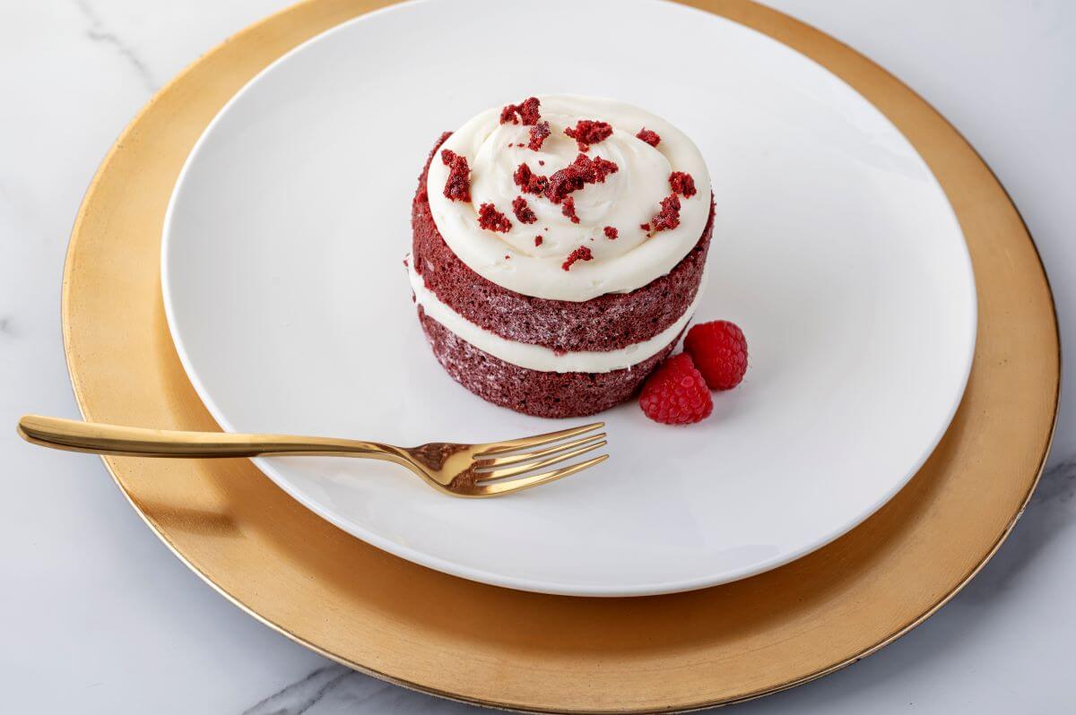 Mini Red Velvet Cakes on a plate with a fork and raspberries.