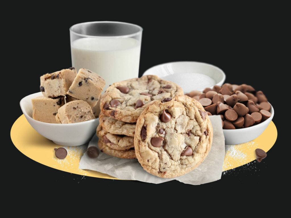 Featured Flavor: Chocolate Chip Cookie Dough in a bowl with baked cookies, chocolate chips, sugar, and a glass of milk