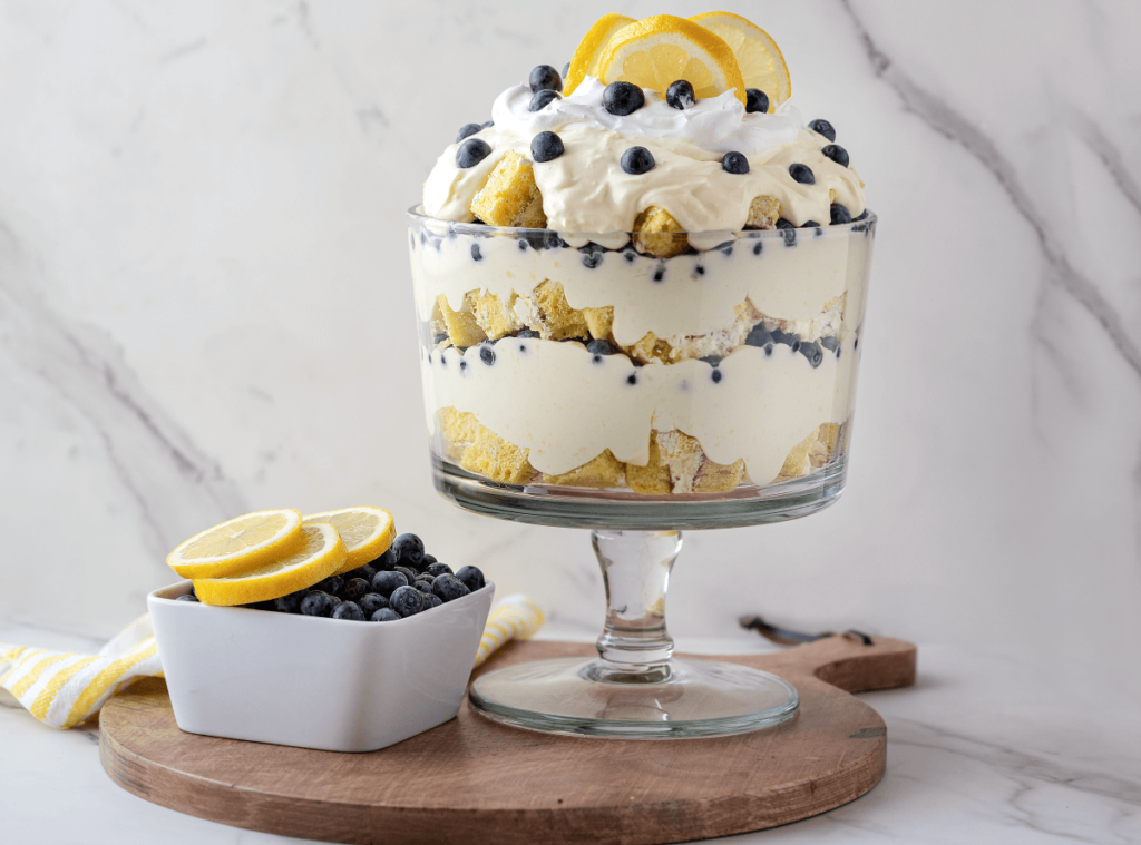 Lemon Blueberry Trifle next to bowl of blueberries and lemon slices