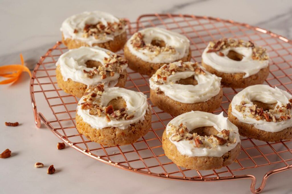 Eight Mini Carrot Cake Donuts on a cooling rack.