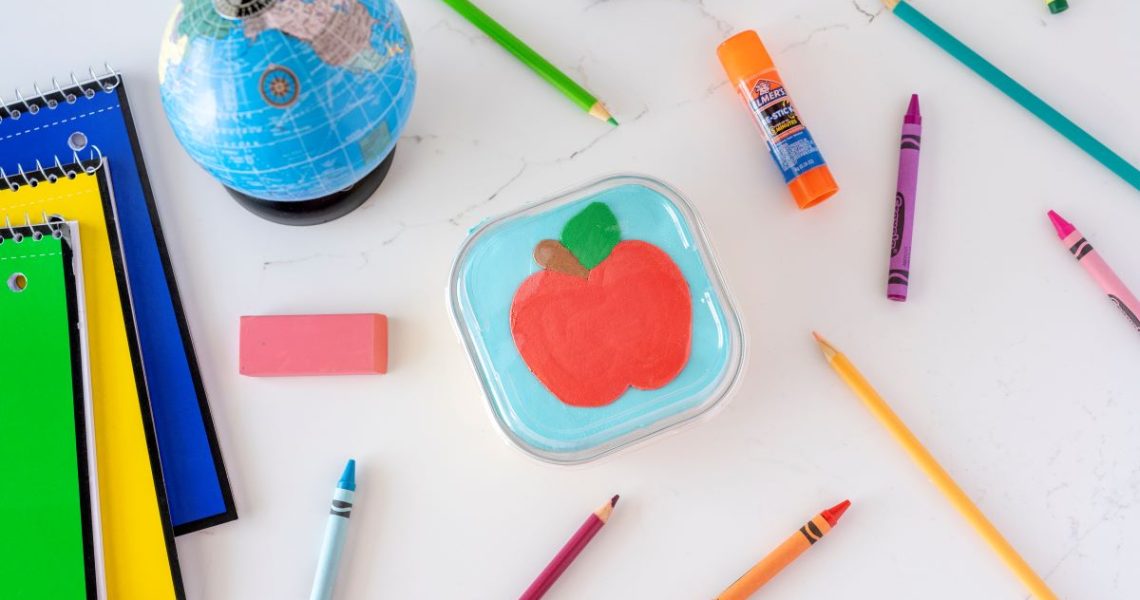 Chocolate Chip Cookie Snack pan - decorated with an icing apple - surrounded by school supplies