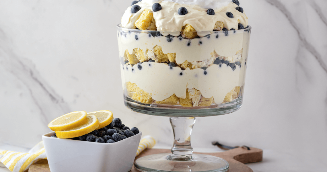 Lemon Blueberry Trifle next to bowl of blueberries and lemon slices